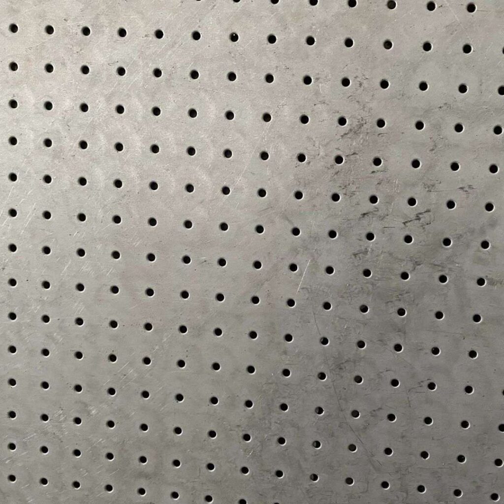 Optimizing Air Pressure with Custom Perforated Metal Sheets - Sudharsun Traders Close-up view of industrial wiremesh rolls stacked in a warehouse setting.