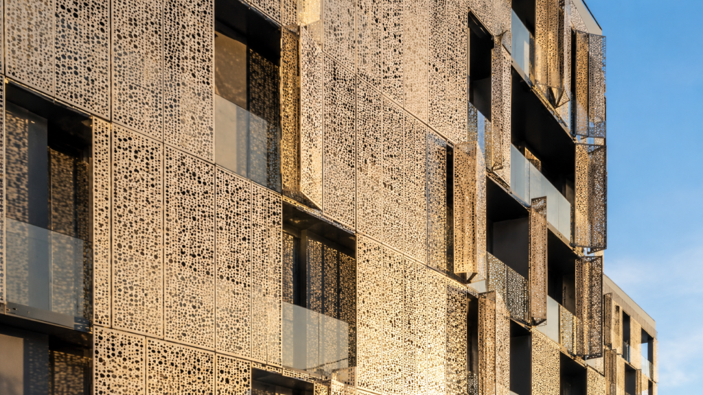 Architect inspecting perforated metal sheets facade panels at Sudharsun Traders