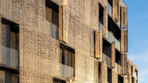 Home - Sudharsun Traders Architect inspecting perforated metal sheets facade panels at Sudharsun Traders