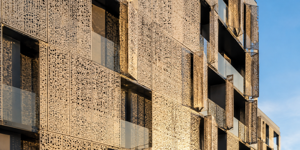 Architect inspecting perforated metal sheets facade panels at Sudharsun Traders